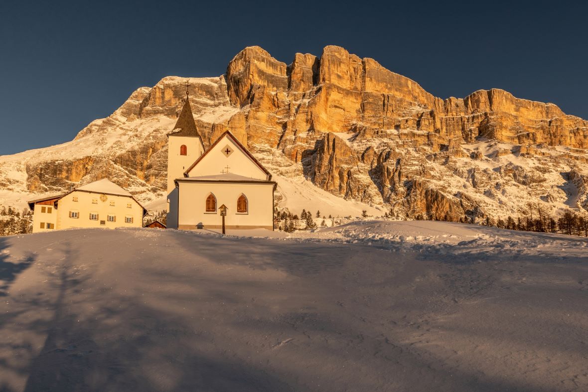 Santa Croce chapel in Alta badia in winter at sunset