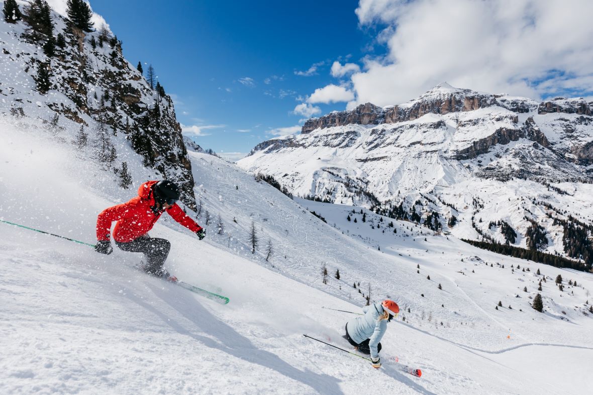 Two skiers on steep ski slope in Arabba-Marmolada ski area