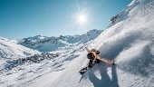 Snowboarder high above Tignes 2100
