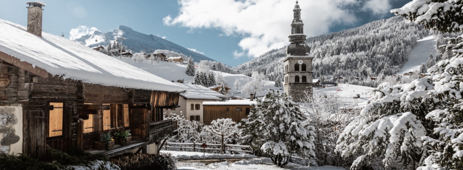 La Clusaz village with its famous church tower surrounded by snow