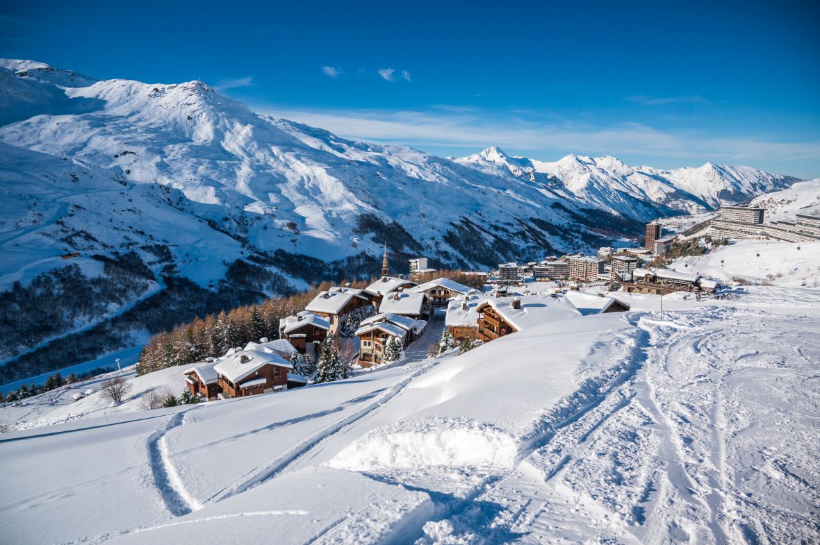 View of Les Menuires ski resort in Les 3 Vallees ski area in winter with ski slopes of la Masse in background